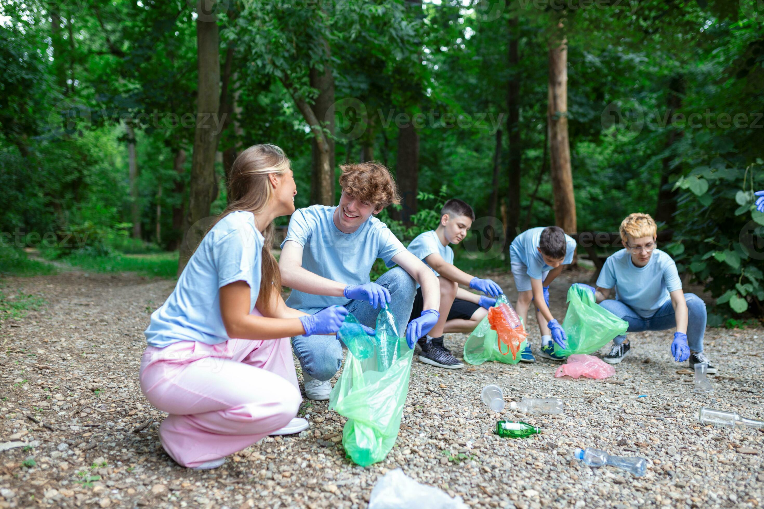 young responsible people doing community charity work in the park group of people cleaning together in public park saving the environment photo.webp